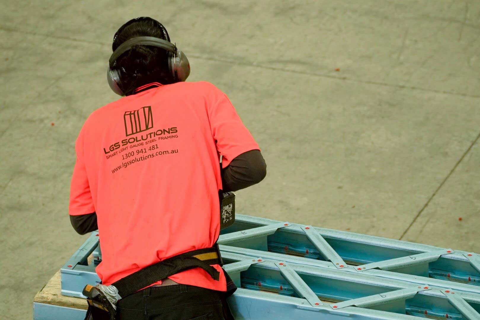 construction worker wearing orange t-shirt and a headset